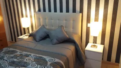 a bedroom with a large bed with two lamps at APARTMENTSUITESPAIN Beach Economy in Valencia