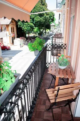 a wooden table and bench on a balcony at Your home in Valencia in Valencia