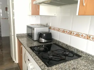 a kitchen counter with a stove and a microwave at Apartament Magnífico in Paiporta