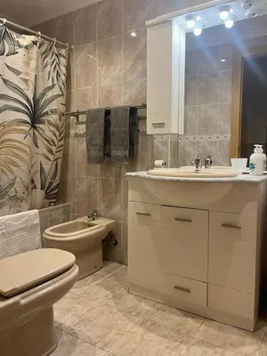 a bathroom with a sink and a toilet and a mirror at Apartament Magnífico in Paiporta