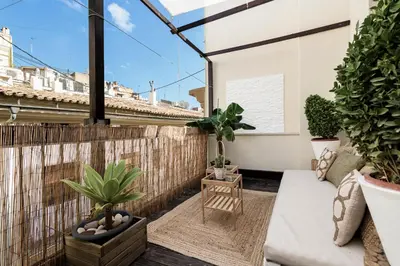 a balcony with potted plants and a couch at TTdSSa VLC Ramellets Street Central Market in Valencia