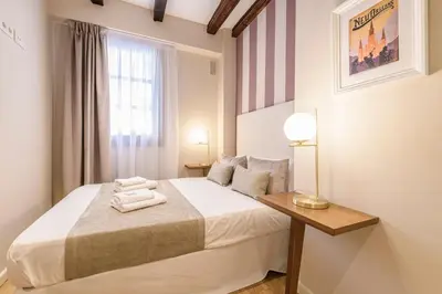 a small bedroom with a bed with towels on it at TTdSSa VLC Ramellets Street Central Market in Valencia