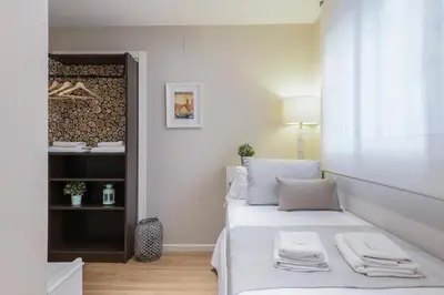 a bedroom with a bed with two towels on it at TTdSSa VLC Ramellets Street Central Market in Valencia