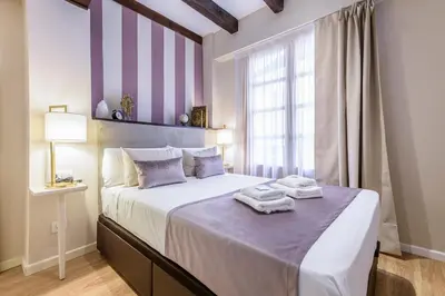 a bedroom with a large bed with towels on it at TTdSSa VLC Ramellets Street Central Market in Valencia