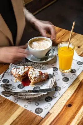a table with a cup of coffee and a plate of food at Concept Rooms in Valencia