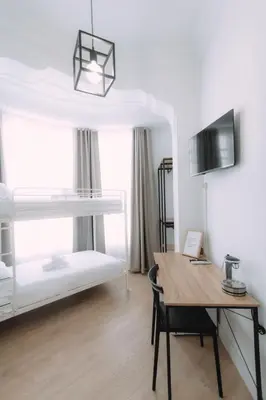 a room with a desk and a bunk bed at Concept Rooms in Valencia
