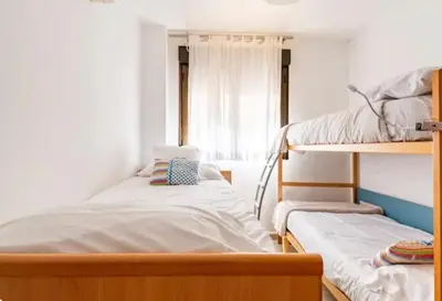 a bedroom with two bunk beds and a window at Casa Dora Puzol playa in Puzol