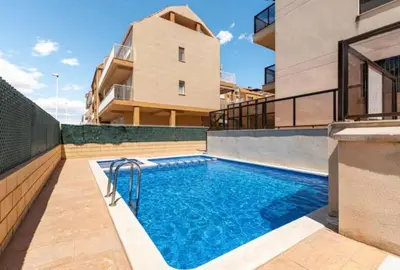 a swimming pool in front of a building at Casa Dora Puzol playa in Puzol