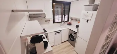 a small white kitchen with a washer and dryer at Casa Dora Puzol playa in Puzol