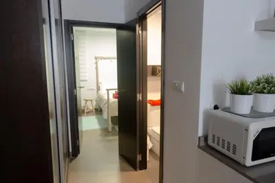 a kitchen with a microwave and a door to a room at Cozy fisherman's house in Valencia