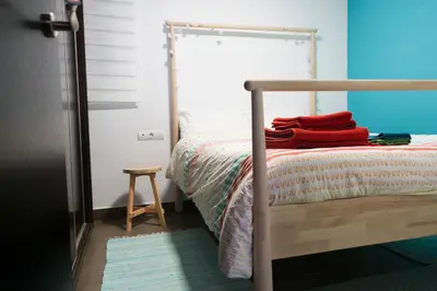 a bedroom with a bunk bed with red towels on it at Cozy fisherman's house in Valencia