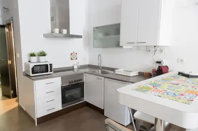 a small kitchen with a microwave and a sink at Cozy fisherman's house in Valencia