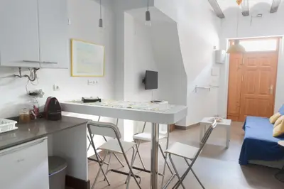 a kitchen with a table and chairs in a room at Cozy fisherman's house in Valencia