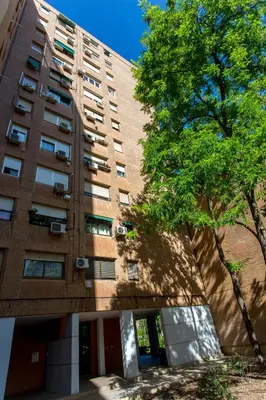 an apartment building with a tree in front of it at Versus Apartments near City of Arts in Valencia