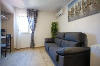 a living room with a couch and a window at Versus Apartments near City of Arts in Valencia