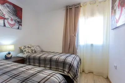 a bedroom with two beds and a window at Versus Apartments near City of Arts in Valencia