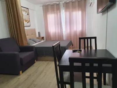 a small living room with a table and a couch at Versus Apartments near City of Arts in Valencia