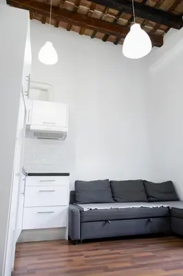 a living room with a couch and white walls at Up Town in Valencia