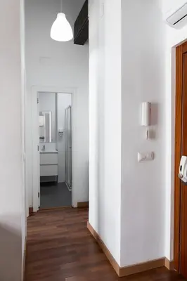 a hallway with white walls and wooden floors at Up Town in Valencia