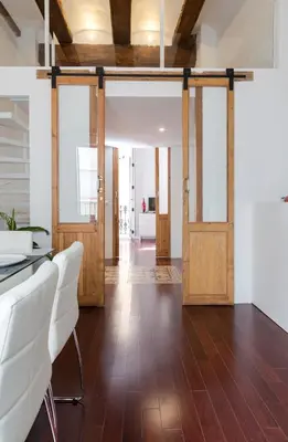 an open office with wooden doors and white chairs at Apartments Downtown Valencia in Valencia