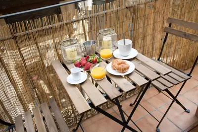 a table with breakfast foods and orange juice on it at Apartment Collado in Valencia