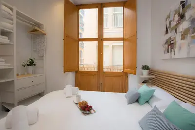 a room with a table with a bowl of fruit on it at Apartment Collado in Valencia