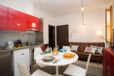 a small kitchen with a white table and a couch at Apartment Collado in Valencia