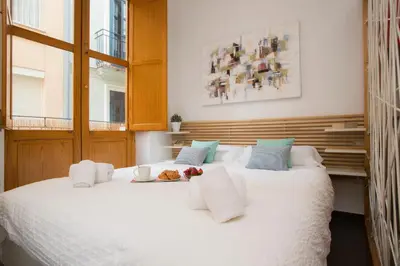 a bedroom with a large white bed with white pillows at Apartment Collado in Valencia
