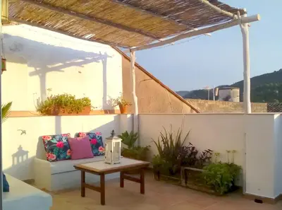 a patio with a couch and a table at Casa Rural La Tramontana in Estivella