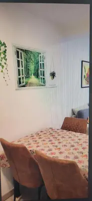 a dining room table with chairs and a window at Apartamento Jardín de Ayora in Valencia