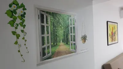 a window view of a forest mural on a wall at Apartamento Jardín de Ayora in Valencia