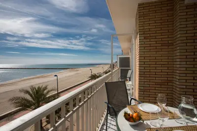 a balcony with a table and a view of the beach at SingularStays El Faro in Puzol