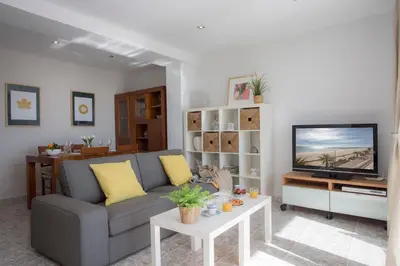 a living room with a couch and a tv at SingularStays El Faro in Puzol