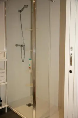 a shower stall with a glass shower door at Apartamento Ribes Valencia in Valencia