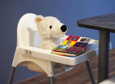 a teddy bear sitting in a chair with a book at Valencian Apartment in Valencia