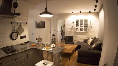 a kitchen and living room with a couch and a table at Valencian Apartment in Valencia