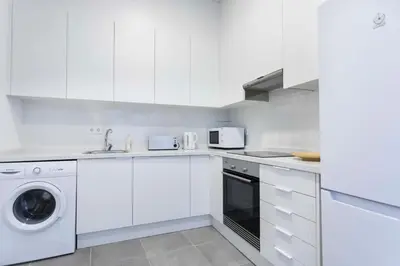 a white kitchen with a sink and a dishwasher at Total Valencia Vintage in Valencia