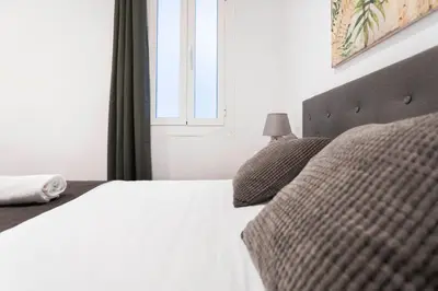 a bedroom with a white bed and a window at Total Valencia Vintage in Valencia