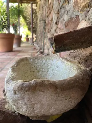 a stone bowl on the side of a stone wall at El Secanet in Algimia de Alfara