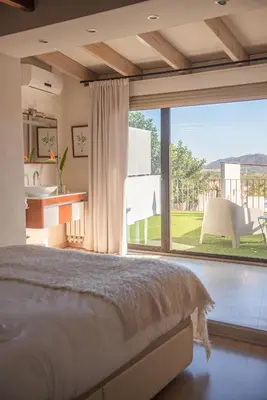 a bedroom with a bed and a large window at El Secanet in Algimia de Alfara
