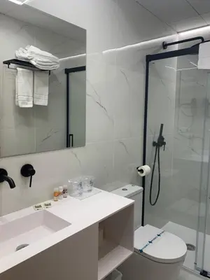 a bathroom with a shower and a toilet and a sink at Hotel Miramar Valencia in Valencia