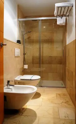 a bathroom with a shower and a toilet and a sink at Hotel Miramar Valencia in Valencia