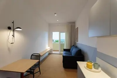 a living room with a blue couch and a table at Hotel Miramar Valencia in Valencia