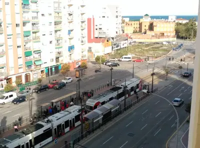 a view of a city with trains on a street at Malvarosa Beach Family in Valencia