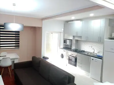 a living room with a couch and a kitchen at Malvarosa Beach Family in Valencia