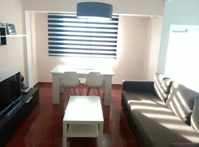 a living room with a couch and a table at Malvarosa Beach Family in Valencia