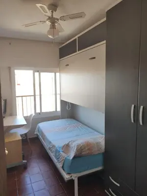 a bedroom with a bed and a ceiling fan at Malvarosa Beach Family in Valencia