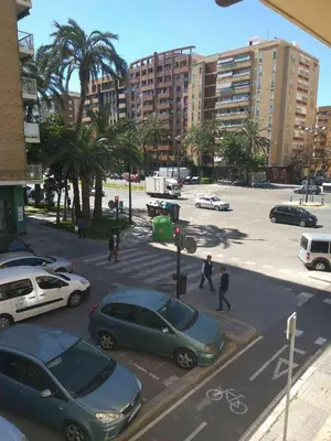 a parking lot with cars parked in a city at Apartment in Valencia in Valencia