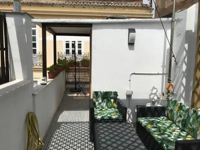 an outdoor patio with two chairs and a couch at Atico En El Centro in Valencia