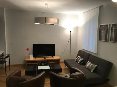 a living room with a couch and a television at Atico En El Centro in Valencia